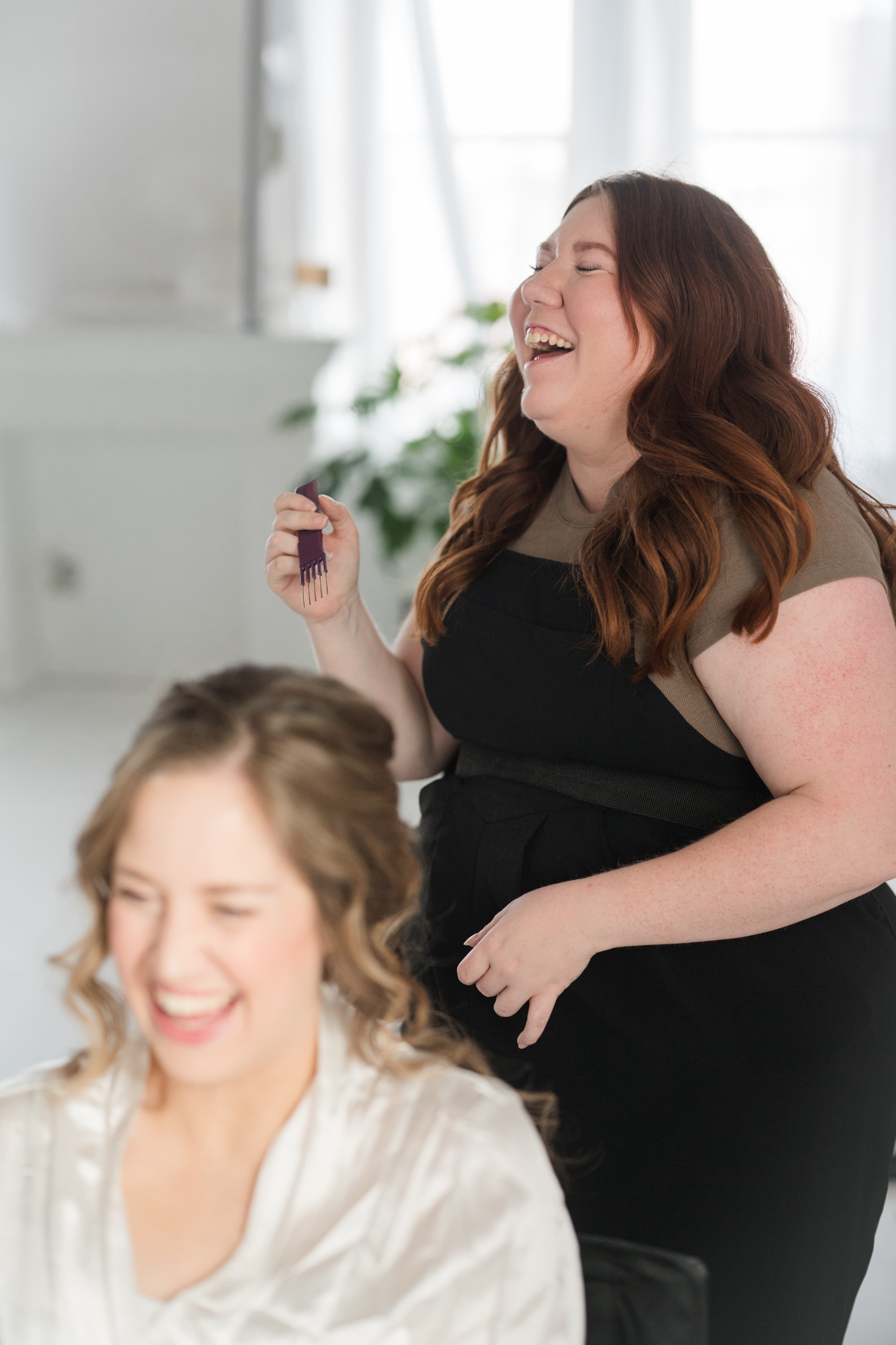 Kat styling a bride's hair in studio